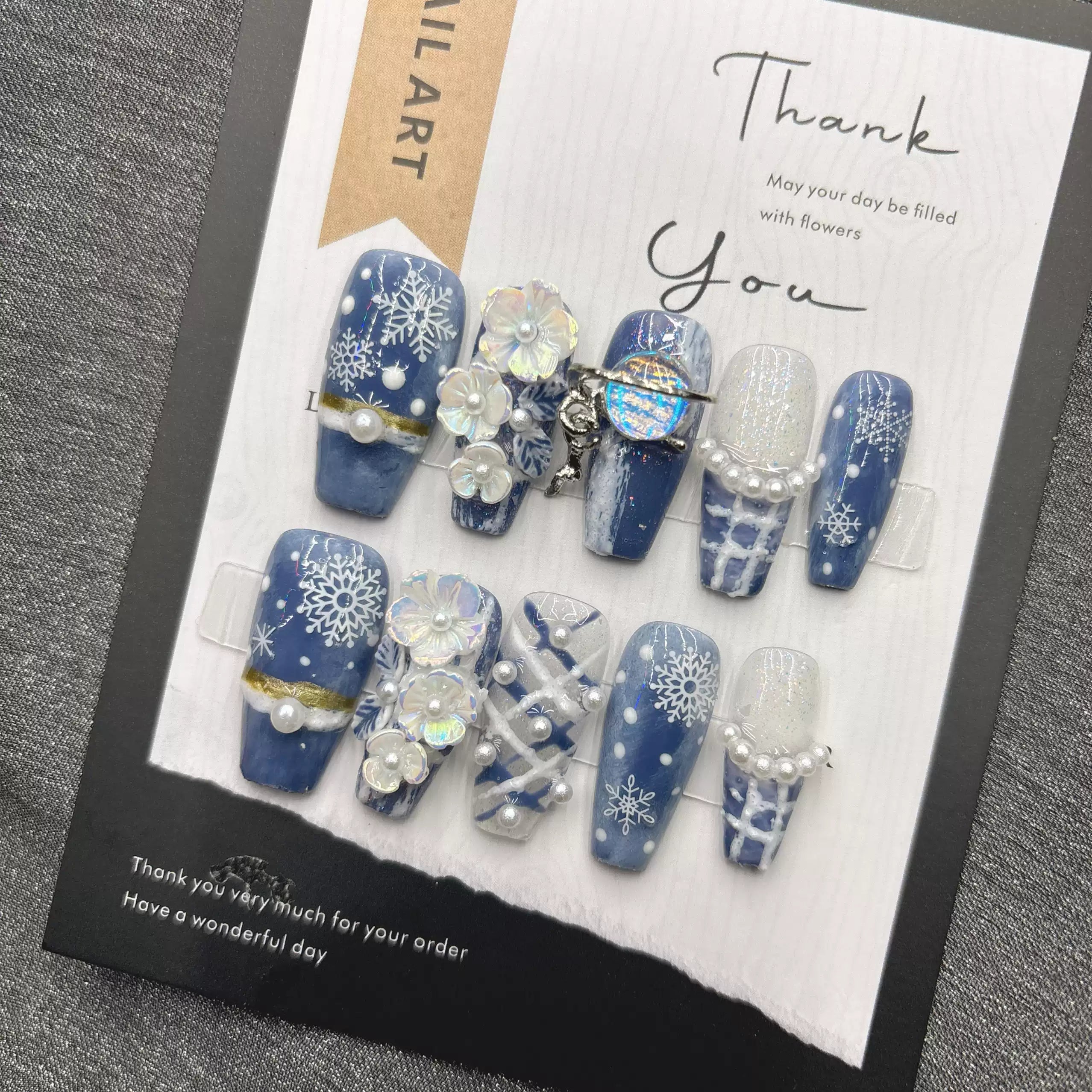 Blue snowflake romantic winter handmade French manicure, a popular trend among online influencers, exuding sophistication and flattering the skin tone, long style, 2026.