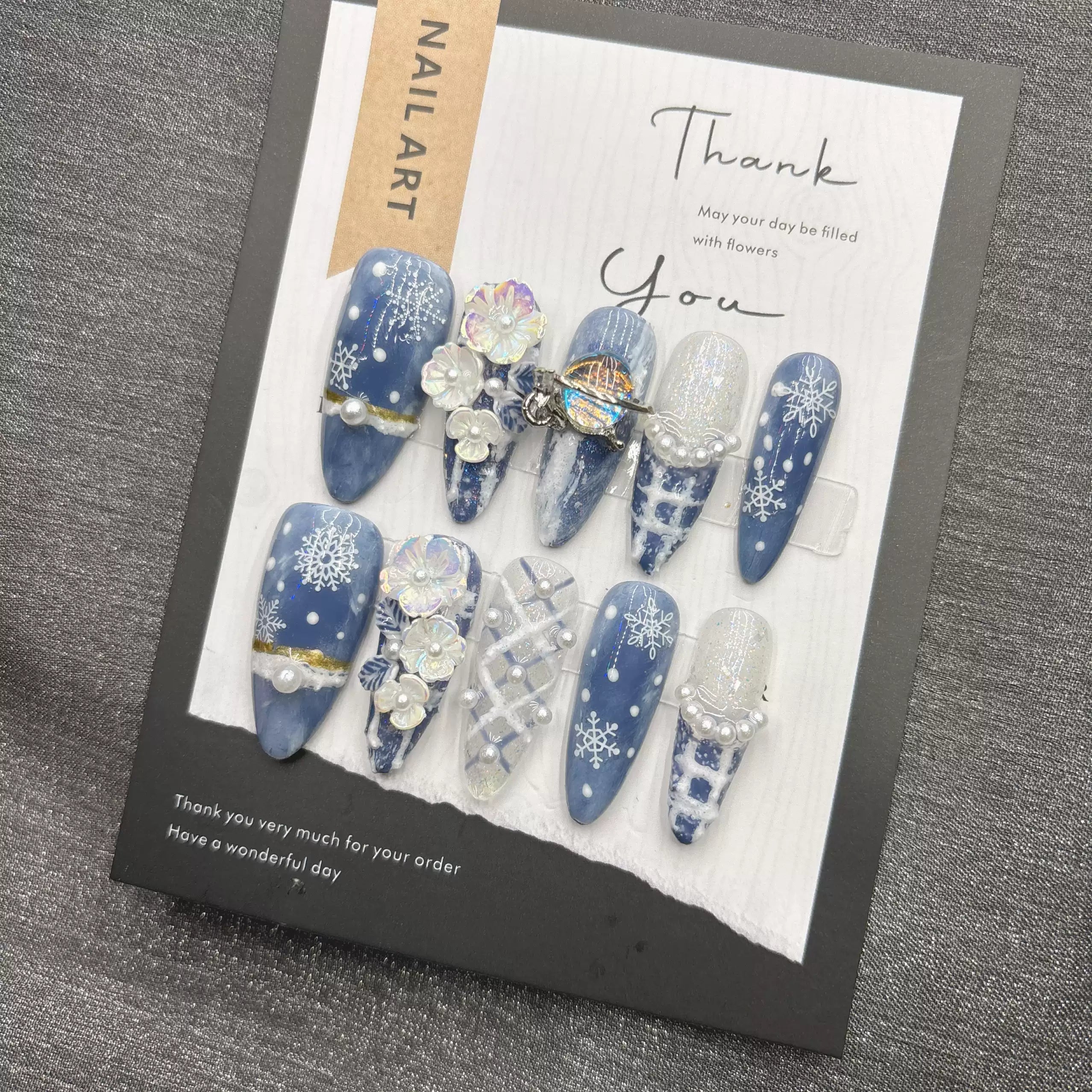 Blue snowflake romantic winter handmade French manicure, a popular trend among online influencers, exuding sophistication and flattering the skin tone, long style, 2026.