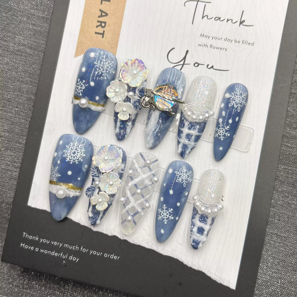 Blue snowflake romantic winter handmade French manicure, a popular trend among online influencers, exuding sophistication and flattering the skin tone, long style, 2026.