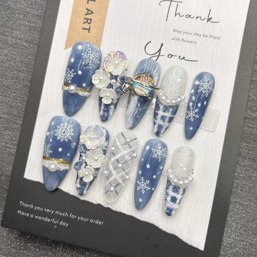 Blue snowflake romantic winter handmade French manicure, a popular trend among online influencers, exuding sophistication and flattering the skin tone, long style, 2026.
