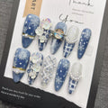 Blue snowflake romantic winter handmade French manicure, a popular trend among online influencers, exuding sophistication and flattering the skin tone, long style, 2026.