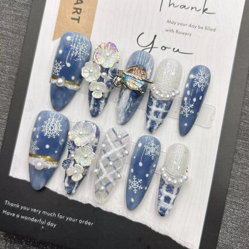 Blue snowflake romantic winter handmade French manicure, a popular trend among online influencers, exuding sophistication and flattering the skin tone, long style, 2026.